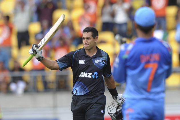 New Zealand's Ross Taylor, left, is applauded by India’s MS Dhoni on reaching his century in the fifth and final one-day international cricket match in Wellington, New Zealand, Friday, Jan. 31, 2014. (AP Photo/SNPA, Ross Setford) NEW ZEALAND OUT