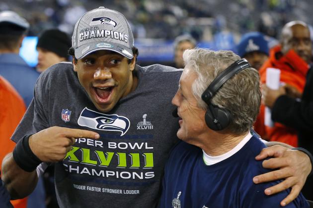 Seattle Seahawks' quarterback Russell Wilson, left, laughs with Seahawks head coach Pete Carroll during a television interview after the NFL Super Bowl XLVIII football game Sunday, Feb. 2, 2014, in East Rutherford, N.J. The Seahawks won 43-8. (AP Photo/Paul Sancya)