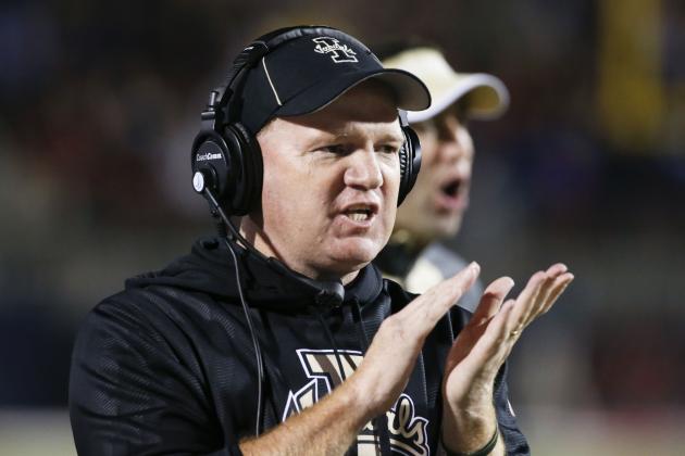 Idaho football coach Paul Petrino cheers on his defensive squad as they leave the field after holding Mississippi during the first half of their NCAA college football game at Vaught-Hemingway Stadium in Oxford, Miss., on Saturday, Oct. 26, 2013.  (AP Photo/Rogelio V. Solis)
