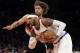 New York Knicks' Carmelo Anthony (7) drives past Portland Trail Blazers' Robin Lopez (42) during the first half of an NBA basketball game, Wednesday, Feb. 5, 2014, in New York. (AP Photo/Frank Franklin II)