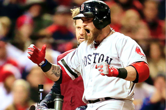 Boston Red Sox's Jonny Gomes places the championship trophy and a