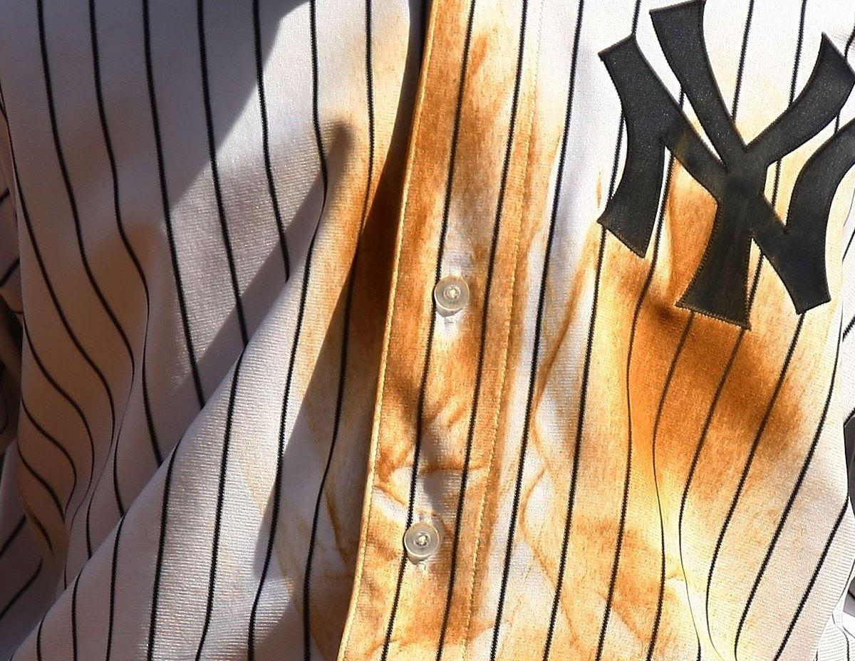Closeup portrait of New York Yankees Jorge Posada with son at