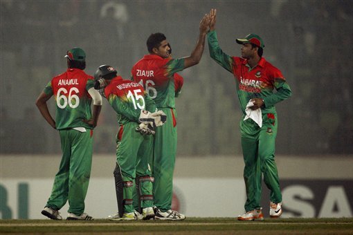 Bangladesh's Abdur Razzak, right, congratulates Ziaur Rahman after the dismissal of West Indies' Kieron Pollard, unseen, during their Twenty20 cricket match in Dhaka, Bangladesh, Monday, Dec. 10, 2012. (AP Photo/Pavel Rahman)