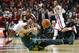 Baylor center Isaiah Austin, bottom, passes the ball in front of Oklahoma guard Buddy Hield in the second half of an NCAA college basketball game in Norman, Okla., Saturday, Feb. 8, 2014. Oklahoma won 88-72. Oklahoma guard Jordan Woodard(10) looks on. (AP Photo/Sue Ogrocki)