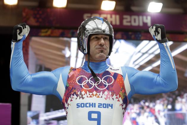 Armin Zoeggeler of Italy celebrates after he crosses the finish area to win the bronze medal during the men's singles luge final at the 2014 Winter Olympics, Sunday, Feb. 9, 2014, in Krasnaya Polyana, Russia.  (AP Photo/Natacha Pisarenko)