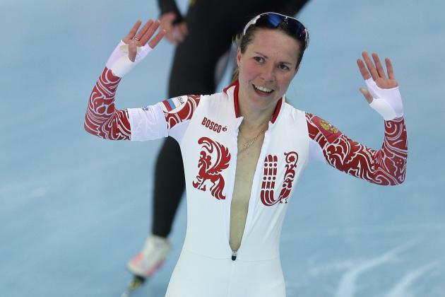 Bronze medallist Olga Graf of Russia celebrates with a wide open front of her skin suit after the women's 3,000-meter speedskating race at the Adler Arena Skating Center during the 2014 Winter Olympics, Sunday, Feb. 9, 2014, in Sochi, Russia. (AP Photo/Pavel Golovkin)