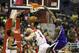 Washington Wizards center Kevin Seraphin, left, looks on as Sacramento Kings small forward Quincy Acy dunks over his teammate Marcin Gortat during the second half of an NBA basketball game, Sunday, Feb. 9, 2014, in Washington. The Wizards defeated the Kings 93-84. (AP Photo/ Evan Vucci)
