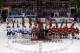 Members of the Vancouver Canucks and the Detroit Red Wings who are playing in the Olympics pose at center ice before the first period of an NHL hockey game in Detroit, Monday, Feb. 3, 2014. (AP Photo/Carlos Osorio)
