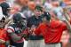 Oregon State head coach Mike Riley, right, congratulates Oregon State running back Terron Ward, center, after the replay official ruled his touchdown good in the second quarter of the Hawaii Bowl NCAA college football game against Boise State, in Honolulu, Tuesday, Dec. 24, 2013. (AP Photo/Eugene Tanner)