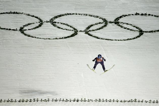 Germany's Carina Vogt jumps over the Olympic Rings on her second run during the women's normal hill ski jumping final at the 2014 Winter Olympics, Tuesday, Feb. 11, 2014, in Krasnaya Polyana, Russia. (AP Photo/Charlie Riedel)