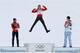 Germany's Eric Frenzel celebrates winning the gold as he is flanked by Japan's silver medal winner Akito Watabe, left, and Norway's bronze medal winner Magnus Krog during the flower ceremony after the cross-country portion of the nordic combined at the 2014 Winter Olympics, Wednesday, Feb. 12, 2014, in Krasnaya Polyana, Russia. (AP Photo/Matthias Schrader)