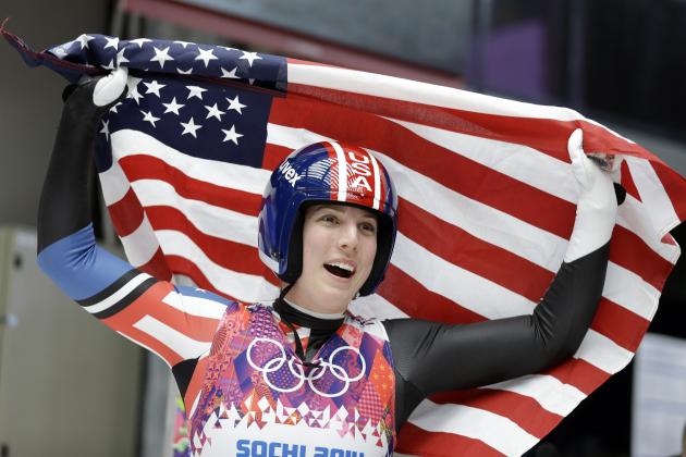Erin Hamlin of the United States waves the flag after finishing her final run to win the bronze medalduring the women's singles luge competition at the 2014 Winter Olympics, Tuesday, Feb. 11, 2014, in Krasnaya Polyana, Russia. (AP Photo/Natacha Pisarenko)