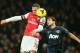 Arsenal's Kieran Gibbs, left, challenges for the ball as he out jumps Manchester United's Rafael during their English Premier League soccer match between Arsenal and Manchester United at the Emirates stadium in London, Wednesday, Feb. 12, 2014. (AP Photo/Alastair Grant)