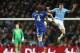 Manchester City's Martin Demichelis, right jumps to challenge Chelsea's David Luiz for the ball during their English Premier League soccer match at the Etihad Stadium, Manchester, England, Monday Feb. 3, 2014. (AP Photo/Jon Super)