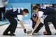 John Shuster, skip of the United States team, center, delivers the rocks to his sweepers John Landsteiner, left, and Jared Zezel during men's curling competition against China at the 2014 Winter Olympics, Tuesday, Feb. 11, 2014, in Sochi, Russia. (AP Photo/Robert F. Bukaty)