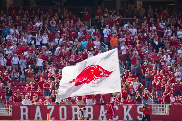 Oct 12, 2013; Fayetteville, AR, USA; A cheerleader carries the Arkansas Razorbacks flag past the crowd during a game against the South Carolina Gamecocks at Donald W. Reynolds Razorback Stadium. South Carolina defeated Arkansas 52-7. Mandatory Credit: Beth Hall-USA TODAY Sports