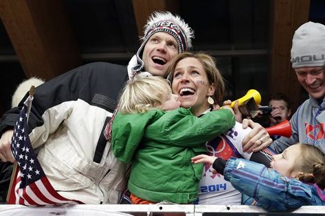 ADDS ID OF MAN AT LEFT - Noelle Pikus-Pace of the United States celebrates with her brother Jared Pikus, left, husband, Janson Pace, far right, and children, Traycen, left, and Lacee, right, after she won the silver medal during the women's skeleton competition at the 2014 Winter Olympics, Friday, Feb. 14, 2014, in Krasnaya Polyana, Russia. (AP Photo/Michael Sohn)