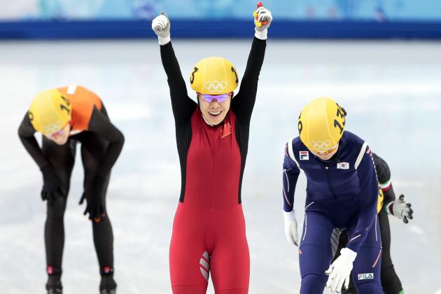 Zhou Yang of China, centre, reacts as she crosses the finish line first in the women's 1500m short track speedskating final at the Iceberg Skating Palace during the 2014 Winter Olympics, Saturday, Feb. 15, 2014, in Sochi, Russia. (AP Photo/Ivan Sekretarev)