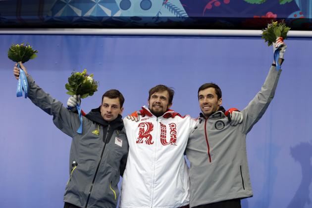 From left to right silver medalist Martins Dukurs of Latvia, gold medalist Alexander Tretiakov of Russia and bronze medalist Matthew Antoine of the United States pose during the flower ceremony after the men's skeleton competition at the 2014 Winter Olympics, Saturday, Feb. 15, 2014, in Krasnaya Polyana, Russia. (AP Photo/Natacha Pisarenko)
