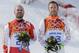 Men's super-G joint bronze medal winners Canada's Jan Hudec, left, and United States' Bode Miller stand on the podium during a flower ceremony at the Sochi 2014 Winter Olympics, Sunday, Feb. 16, 2014, in Krasnaya Polyana, Russia. (AP Photo/Christophe Ena)