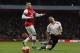 Liverpool's Luis Suarez, right, is tackled by Arsenal's Alex Oxlade-Chamberlain during their English FA Cup fifth round soccer match at Emirates Stadium in London, Sunday, Feb. 16, 2014. (AP Photo/Sang Tan)