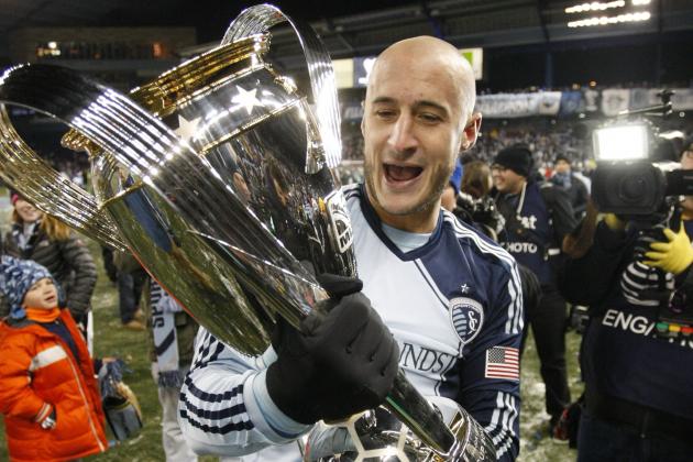Sporting Kansas City's Most Valuable Player Aurelien Collin holds the MLS Cup after defeating Real Salt Lake in the MLS Cup final soccer match in Kansas City, Kan., Saturday, Dec. 7, 2013. (AP Photo/Colin E. Braley)