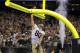 New Orleans Saints tight end Jimmy Graham (80) slam dunks over the goalpost after scoring on a touchdown reception in the second half of an NFL football game against the Arizona Cardinals in New Orleans, Sunday, Sept. 22, 2013. (AP Photo/Bill Haber)