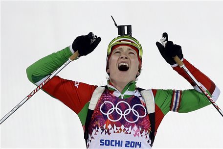 Belarus' Darya Domracheva celebrates winning the gold medal in the women's biathlon 12.5k mass-start, at the 2014 Winter Olympics, Monday, Feb. 17, 2014, in Krasnaya Polyana, Russia. (AP Photo/Kirsty Wigglesworth)