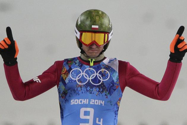 Poland's Kamil Stoch raises his arms after his second attempt during the ski jumping large hill team competition at the 2014 Winter Olympics, Monday, Feb. 17, 2014, in Krasnaya Polyana, Russia. (AP Photo/Matthias Schrader)