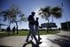 Texas Rangers' Matt Harrison and Colby Lewis walk to the practice field before taking in a morning workout during spring training baseball practice, Monday, Feb. 17, 2014, in Surprise, Ariz. (AP Photo/Tony Gutierrez)