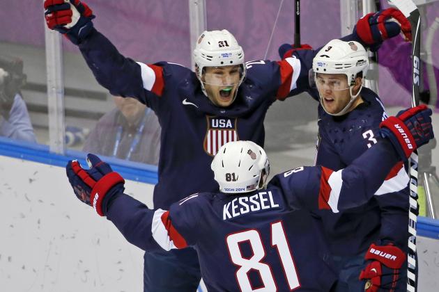 USA forward James van Riemsdyk, defenseman Cam Fowler and USA forward Phil Kessel celebrate a goal by Fowler in the second period of a men's ice hockey game against Russia at the 2014 Winter Olympics, Saturday, Feb. 15, 2014, in Sochi, Russia. (AP Photo/Petr David Josek)