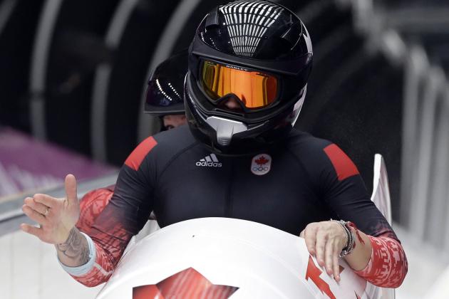 The team from Canada CAN-1, piloted Kaillie Humphries with brakeman Heather Moyse, brake in the finish area after their second run during the women's two-man bobsled competition at the 2014 Winter Olympics, Tuesday, Feb. 18, 2014, in Krasnaya Polyana, Russia. (AP Photo/Dita Alangkara)