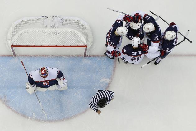 Team USA celebrates Phil Kessel's (81) goal against Slovakia goaltender Jaroslav Halak during the 2014 Winter Olympics men's ice hockey game at Shayba Arena, Thursday, Feb. 13, 2014, in Sochi, Russia. (AP Photo/Matt Slocum)
