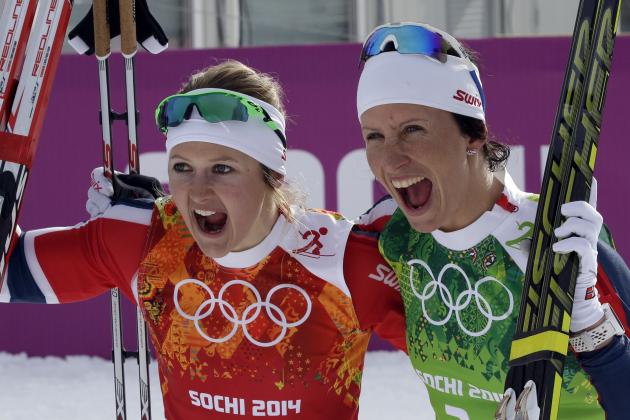 Norway's Marit Bjoergen, left, and Ingvild Flugstad Oestberg celebrate winning the gold medal in the cross-country team sprint competitions at the 2014 Winter Olympics, Wednesday, Feb. 19, 2014, in Krasnaya Polyana, Russia. (AP Photo/Lee Jin-man)