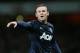 Manchester United's Wayne Rooney gestures to his teammates during their English Premier League soccer match between Arsenal and Manchester United at the Emirates stadium in London, Wednesday, Feb. 12, 2014. (AP Photo/Alastair Grant)
