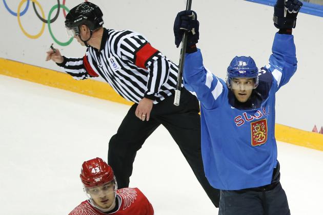 Finland forward Juhamatti Aaltonen, right, and Russia forward Valeri Nichushkin react after Finland scored a goal in the first period of a men's quarterfinal ice hockey game at the 2014 Winter Olympics, Wednesday, Feb. 19, 2014, in Sochi, Russia. (AP Photo/Mark Humphrey)