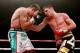 HULL, ENGLAND - JULY 13: Derry Matthews (L) in action with Tommy Coyle during their Vacant Commonwealth Lightweight Championship bout at Craven Park Stadium on July 13, 2013 in Hull, England. (Photo by Scott Heavey/Getty Images)