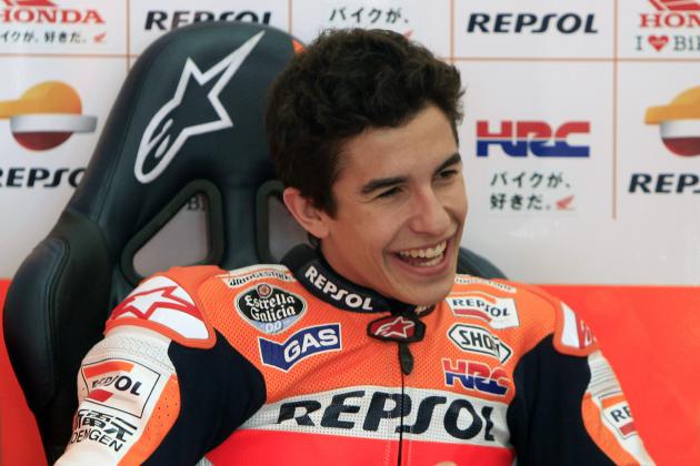 MotoGP rider Marc Marquez of Spain laughs as he speaks to a crew member during a pre-season test at Sepang International Circuit in Sepang, Malaysia, Tuesday, Feb. 4, 2014. (AP Photo/Lai Seng Sin)