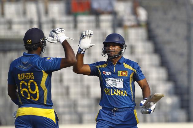 Sri Lanka’s Kumar Sangakkara, right, celebrates with his teammate Angelo Mathews after scoring a century during the second one day international (ODI) cricket match against Bangladesh in Dhaka, Bangladesh, Thursday, Feb. 20, 2014. (AP Photo/A.M. Ahad)
