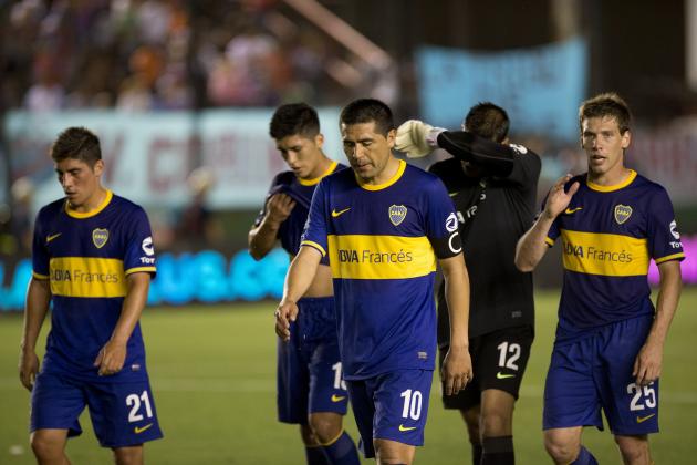 Boca Juniors' Juan Roman Riquelme leaves the field with teammates after the first half against Arsenal at an Argentine league soccer match in Buenos Aires, Argentina, Sunday, Nov. 17, 2013. (AP Photo/Eduardo Di Baia)