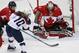 Goalkeeper Shannon Szabados of Canada (1) blocks a shot on goal by Meghan Duggan of the United States (10) during the first period of the women's gold medal ice hockey game at the 2014 Winter Olympics, Thursday, Feb. 20, 2014, in Sochi, Russia. (AP Photo/Petr David Josek)
