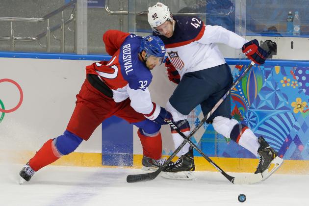 Czech Republic defenseman Michal Rozsival and USA forward David Backes battle for control of the puck during the second period of men's quarterfinal hockey game in Shayba Arena at the 2014 Winter Olympics, Wednesday, Feb. 19, 2014, in Sochi, Russia. (AP Photo/Matt Slocum)