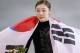 Yuna Kim of South Korea celebrates her second place with the national flag following the flower ceremony for the women's free skate figure skating finals at the Iceberg Skating Palace during the 2014 Winter Olympics, Thursday, Feb. 20, 2014, in Sochi, Russia. (AP Photo/Vadim Ghirda)