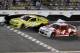 Matt Kenseth (20) races to the finish ahead of Kevin Harvick (4) to win the first of two NASCAR Sprint Cup series qualifying auto races at Daytona International Speedway in Daytona Beach, Fla., Thursday, Feb. 20, 2014. (AP Photo/Terry Renna)