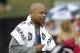 New York Giants general manager Jerry Reese wears a towel in a light rain during a practice at the New York Giants NFL football training camp in Albany, N.Y., Saturday, July 28, 2012. (AP Photo/Kathy Willens)