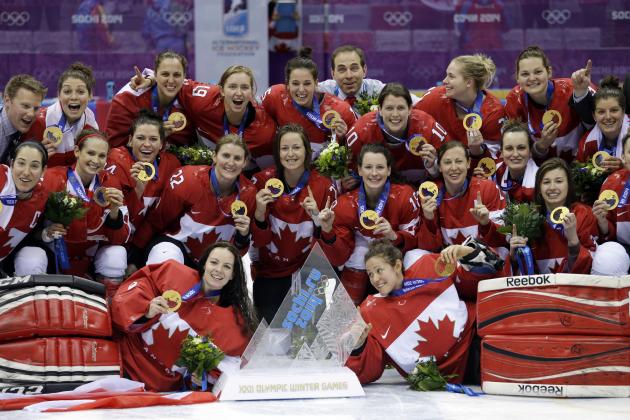 Team Canada gathers for a group photo after beating the USA 3-2 in overtime of the gold medal women's ice hockey game at the 2014 Winter Olympics, Wednesday, Feb. 19, 2014, in Sochi, Russia. (AP Photo/David Goldman)
