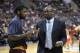 Cleveland Cavaliers head coach Mike Brown, right, talks to Kyrie Irving during a time out in the second half of an NBA basketball game against the Philadelphia 76ers on Tuesday, Feb. 18, 2014, in Philadelphia. The Cavaliers defeated the 76ers 114-85. (AP Photo/Michael Perez)
