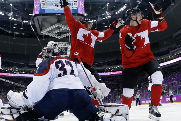 Canada forward Benn Jamie, left, reacts after scoring a goal in front of USA goaltender Jonathan Quick of a men's semifinal ice hockey game at the 2014 Winter Olympics, Friday, Feb. 21, 2014, in Sochi, Russia. (AP Photo/Julio Cortez, Pool)
