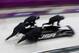 The team from the United States USA-1, piloted by Steven Holcomb, start a run during the men's four-man bobsled training at the 2014 Winter Olympics, Friday, Feb. 21, 2014, in Krasnaya Polyana, Russia. (AP Photo/Dita Alangkara)