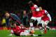 LONDON, ENGLAND - FEBRUARY 19: Mario Goetze of Bayern Muenchen clashes with Mathieu Flamini and Bacary Sagna of Arsenal during the UEFA Champions League Round of 16 first leg match between Arsenal and FC Bayern Muenchen at Emirates Stadium on February 19, 2014 in London, England. (Photo by Shaun Botterill/Getty Images)